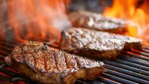 0 grilling steaks on flaming grill and shot with selective focus.jpg